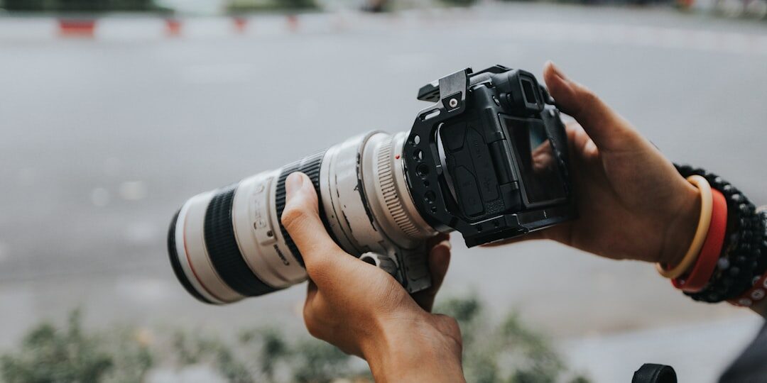 Close-up of a professional news camera lens outdoors